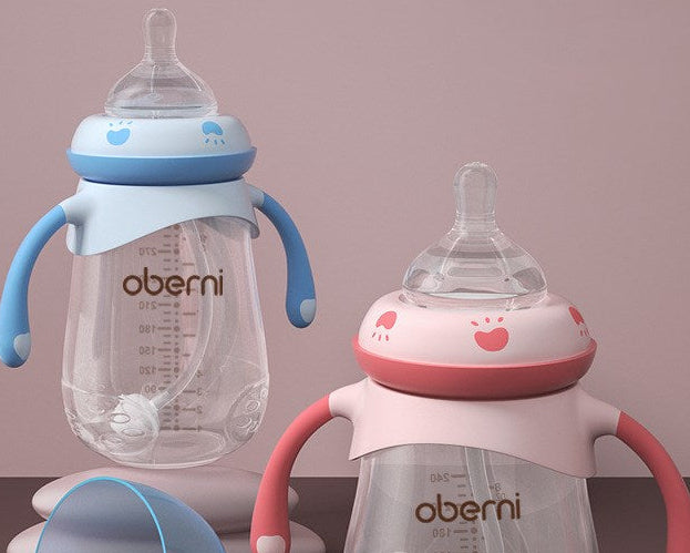Two baby bottles with handles, one blue and one pink, on a gradient background.